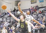  ?? ?? Left: Rockmart's Trevian Tibbs (right) contends with North Murray's Isaiah Morrison for a rebound during a Region 7-AA contest Friday, Feb. 2, at Rockmart High School. Right: Rockmart's Kyla Marcos (left) battles with a North Murray player for a loose ball during a Region 7-AA contest Friday, Feb. 2, at Rockmart High School.