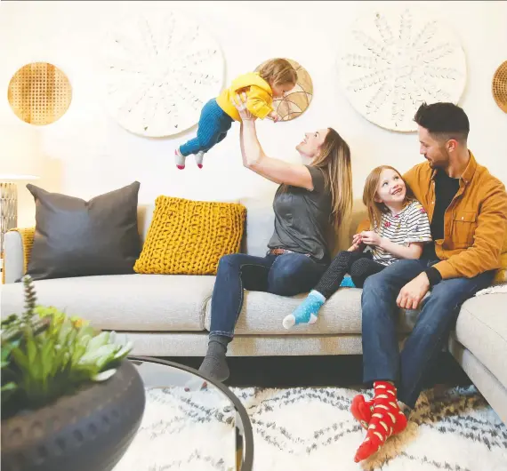  ?? CHRISTINA RYAN ?? Bryan Masson and Jessica Callaway play with their kids Vienna Callaway, 7, and Mylo Masson, 1, in a Genesis Builders Group showhome in Airdrie.