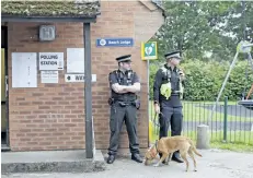  ?? ALASTAIR GRANT/THE ASSOCIATED PRESS ?? Police officers stand outside a polling station in Maidenhead, England, before Britain’s Prime Minister Theresa May arrived to vote on Thursday.