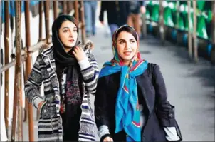  ?? KENARE/AFP ATTA ?? Iranian women wearing hijab walk down a street in the capital Tehran on February 7.