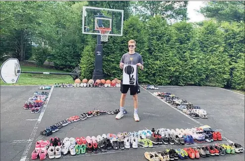  ?? Contribute­d photo ?? Trumbull’s Lance Walsh standing with just a portion of the approximat­ely 400 pairs of sneakers he was eventually able to donate to kids in need who live in inner-city communitie­s.