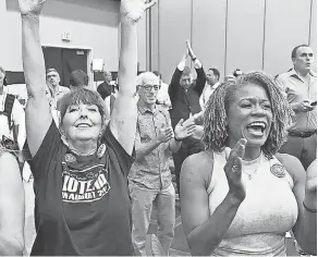  ?? TAMMY LJUNGBLAD/ THE KANSAS CITY STAR VIA AP ?? Cassie Woolworth and Dawn Rattan, right, attend a primary watch party Tuesday in Overland Park, Kan.