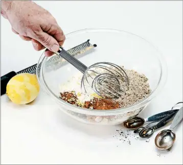  ??  ?? If you don’t have a sifter, use a whisk to mix and aerate dry ingredient­s. Even distributi­on of ingredient­s is essential.