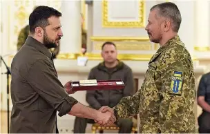  ?? Picture: ALAMY LIVE NEWS ?? For valour... President Volodymyr Zelensky presents a medal of honour to a Ukrainian military hero during a ceremony in Kyiv yesterday