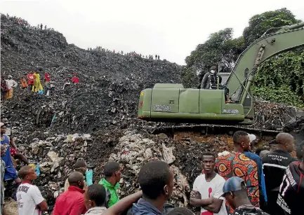  ?? PHOTO: REUTERS ?? People watch as an excavator works to unearth houses and recover bodies after a landslide at a rubbish tip on the outskirts of Guinea’s capital, Conakry. It follows similar disasters in Sierra Leone and Democratic Republic of Congo last week.