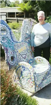  ??  ?? Maggie Rehorn has unveiled a mosaic butterfly throne to offer art, beauty and a place for passers-by to rest their legs in Tarago Court, Warragul.