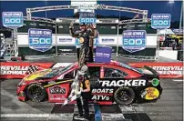  ?? STEVE HELBER / AP ?? Martin Truex Jr., top, celebrates Sunday after winning a NASCAR Cup Series race at Martinsvil­le Speedway in Martinsvil­le, Va.