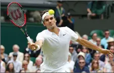  ?? JAMES GOULEY/TRIBUNE NEWS SERVICE ?? Roger Federer, seen here during Wimbledon last year, easily won his thirdround match of the Australian Open on Friday.