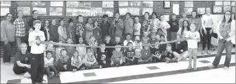  ?? Mona Weatherly ?? Above, children of the Super Kids Club and staff members with Director Megan Crawford at far right, prepare for a ribbon cutting March 31. The after-school program and summer program is for grades Kindergart­en through Fifth. Currently there are 125 children enrolled. Enrollment for the 2022-2023 school year will start soon, according to director Megan Crawford. Mayor Sonnichsen thanked Crawford and the Super Kids Club staff for the work they do, saying, “You do great things for the youth.”