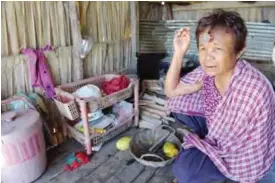  ??  ?? CAMBODIA: This photo shows Chhum Long, whose daughter was a surrogate mother, sitting in her kitchen in the village of Puth Sar in Takeo province.