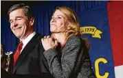  ?? Gerry Broome / Associated Press ?? North Carolina Democratic candidate for governor Roy Cooper and his wife, Kristin, greet supporters during an election night rally in Raleigh, N.C.