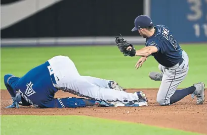  ?? JON BLACKER THE CANADIAN PRESS ?? George Springer slides safely into second base with a fourth-inning double, the Blue Jays’ only extra-base hit Tuesday.