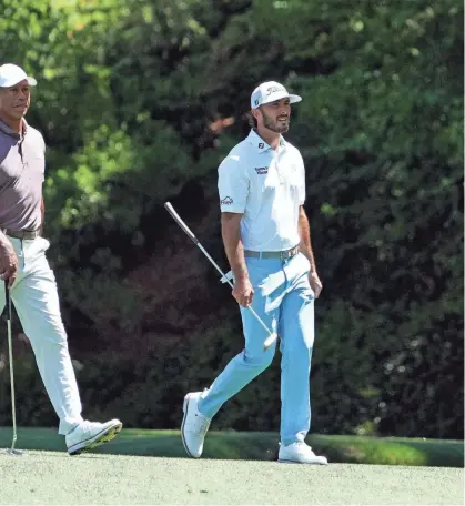  ?? KYLE TERADA/USA TODAY NETWORK ?? Tiger Woods and Max Homa walk on the 13th hole during the second round of the Masters at Augusta National Golf Club on Friday.