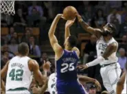  ?? WINSLOW TOWNSON — THE ASSOCIATED PRESS ?? Boston Celtics’ Kyrie Irving blocks a shot by Philadelph­ia 76ers’ Ben Simmons during the fourth quarter of Boston’s 108-97 win in an NBA basketball game in Boston on Thursday.