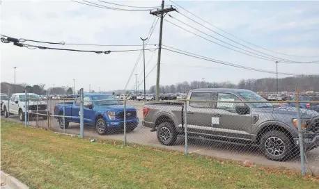  ?? SPECIAL TO THE FREE PRESS ?? Several 2021 F-150 pickups are parked for final inspection near Detroit Metro Airport on Friday.