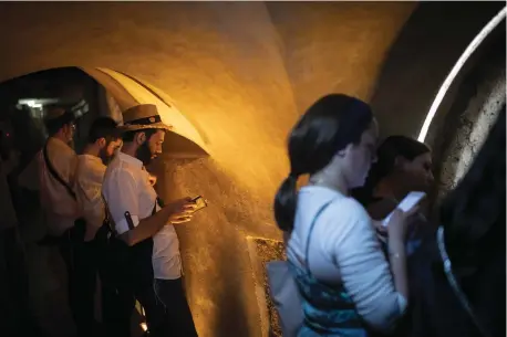  ?? (Hadas Parush/Flash90) ?? PRAYING IN a Western Wall tunnel at the closest physical point (not under Islamic Wakf jurisdicti­on) to the Holy of Holies, in Jerusalem’s Old City last year.