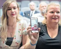  ?? CP PHOTO ?? Retired sergeant Lewis Pearce is on the phone held by his daughter Lisa after the family donated military manuals at the Military Museum in Calgary on Friday.