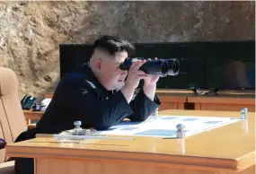  ?? (Reuters) ?? NORTH KOREAN leader Kim Jong-un observes the test-fire of an interconti­nental ballistic missile according to the country’s Central News Agency in Pyongyang, which released this undated photo on July 4.