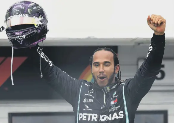  ??  ?? Race winner Lewis Hamilton celebrates his latest victory.