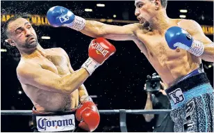  ?? Getty Images ?? PACKING A PUNCH: Danny Garcia, nailing Paul Malignaggi during a 2015 fight, will battle Keith Thurman at Barclays Center on Saturday night in a welterweig­ht unificatio­n bout.