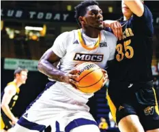  ?? ?? UTC forward Silvio De Sousa, left, drives to the basket against the College of Wooster on Thursday.