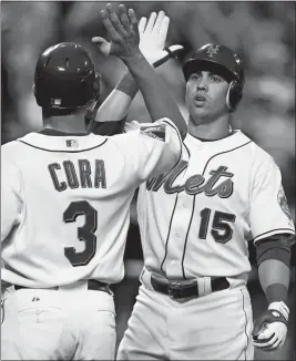  ?? KATHY WILLENS/AP PHOTO ?? In this June 9, 2009 file photo, Alex Cora of the Mets (3) greets Carlos Beltran at the plate after Beltran’s home run against the Phillies at Citi Field in New York.