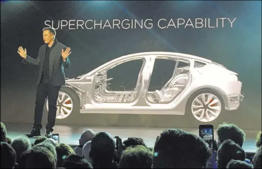  ?? JUSTIN PRITCHARDB­V/THE ASSOCIATED PRESS ?? Tesla Motors Inc. CEO Elon Musk speaks at the unveiling of the Model 3 at the Tesla Motors design studio in 2016 in Hawthorne, Calif. More than 276,000 people pre-ordered the Tesla Model 3 in less than a week. Is it the Tesla phenomenon, or has the...