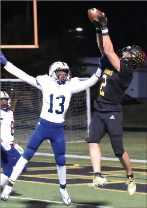  ?? JASON SCHMITT — FOR MEDIANEWS GROUP ?? Madison Heights Bishop Foley senior Adam Kidder goes up over Clawson freshman Jordan Davenport during the first half of Friday night’s Division 6district semifinal playoff game at Bishop Foley High School. The Ventures defeated the Trojans, 49-7, to improve to 10-0 overall.