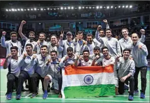  ?? (AFP) ?? Members of the Indian men’s badminton team celebrate after defeating Indonesia in the men’s finals of the Thomas and Uber Cup badminton tournament in Bangkok on Sunday.