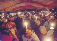  ?? MARLA BROSE/JOURNAL ?? Hundreds raise candles during a vigil a year ago today at Minium Park in Aztec to honor the three victims of a school shooting at Aztec High on Dec. 7, 2017.