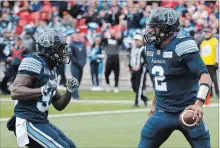  ?? COLE BURSTON THE CANADIAN PRESS ?? Argonauts quarterbac­k James Franklin, right, celebrates his touchdown with teammate Brandon Burks during first-half CFL action against the Montreal Alouettes in Toronto on Saturday. Toronto won, 26-22.