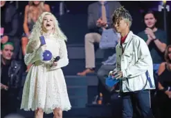  ??  ?? Zara Larsson, left, is presented with best newcomer award by Jaden Smith.