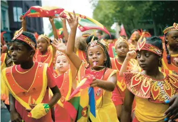  ?? YUI MOK/PA ?? A light day in London: Participan­ts dance to the rhythmic beats during the Children’s Day Parade, part of the Notting Hill Carnival celebratio­n Sunday in west London. Youngsters donned special attire and joined in the procession.