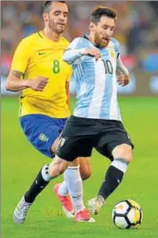  ?? AFP ?? Argentina’s Lionel Messi (right) controls the ball as Renato Augusto (left) tries to tackle during a friendly match at MCG.