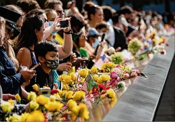  ?? John Minchillo / Associated Press ?? Members of the public arrive to the south pool after the conclusion of ceremonies to commemorat­e the 20th anniversar­y of the Sept. 11 terrorist attacks, Saturday at the National September 11 Memorial & Museum in New York.