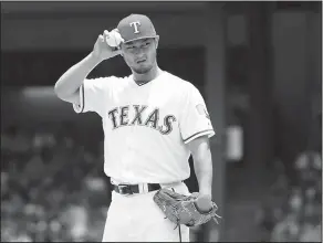  ?? Associated Press ?? Headed to the Dodgers: In this July 9, 2017, file photo, Texas Rangers starting pitcher Yu Darvish adjusts his hat as he works the first inning of a baseball game against the Los Angeles Angels in Arlington, Texas. Darvish was traded to the Los Angeles...