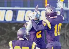  ?? Jenn March / Special to the Times Union ?? Troy’s Jaylen Riggins (10) congratula­tes Xavier Leigh (2) for a touchdown during a game against Queensbury.