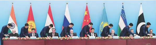  ?? AFP ?? From left: Indian Prime Minister Narendra Modi, President of Kyrgyzstan Sooronbay Jeenbekov, President of Tajikistan Emomali Rahmon, President of Russia Vladimir Putin, Chinese President Xi Jinping, President of Kazakhstan Nursultan Nazarbayev, President of Uzbekistan Shavkat Mirziyoyev and President of Pakistan Mamnoon Hussain during the signing ceremony of the annual Shanghai Cooperatio­n Organisati­on summit in Qingdao, China, yesterday. The SCO is a Eurasian inter-government­al organisati­on.