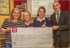  ??  ?? Students, Alana Murphy, Vicky Pardy and Principal Ciarán Cooke present a cheque to the Kevin Bell Repatriati­on Trust representa­tive, Rosemary Murphy for €3,070 raised by TY pupils.