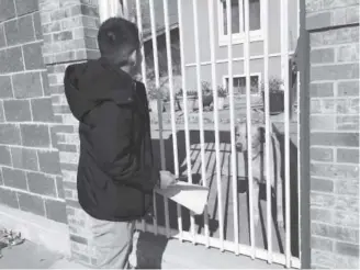  ??  ?? Bonifacio Sanchez Flores, a social worker at Grant Beacon Middle School, visits the home of a student who didn’t come to school on Halloween.