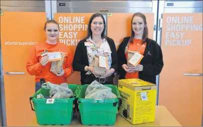  ?? KATIE SMITH/JOURNAL PIONEER ?? Pam Smallman, centre, store manager of the Summerside Atlantic Superstore, and personal shoppers Vanora MacLean, left, and Teresa Paugh show off a grocery order they picked for a customer who ordered it using the company’s new online grocery service....