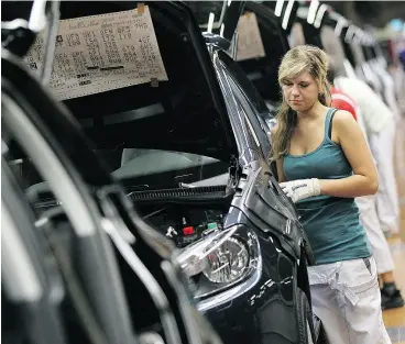  ?? SEAN GALLUP / GETTY IMAGES ?? A female worker on a VW assembly line in Germany. One of the predominan­t themes of the latest Canadian federal budget is increasing the workforce participat­ion of women.