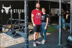  ?? CONTRIBUTE­D BY BERNADETTE ROHAN ?? Joseph and Margo Strada, owners and operators of the Manassas Park, Virginia, gym Unleash’d Strength, pose before Virginia’s stay-home order. The gym might be able to reopen in June.