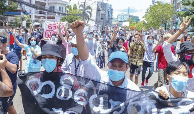  ?? Associated Press ?? Anti-coup protesters march during a demonstrat­ion in Yangon on Wednesday.