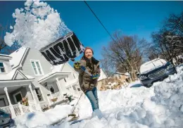  ?? JAKE MAY/THE FLINT JOURNAL ?? Boris Yakubchik clears his driveway with a shovel Saturday in Lapeer, Mich., after a heavy snowstorm dropped a recorded 9 inches of snow overnight.