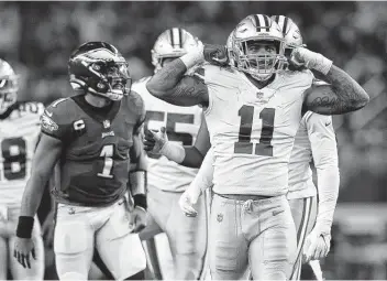  ?? Tom Pennington / Getty Images ?? Cowboys rookie Micah Parsons takes advantage of a chance to show off after helping out on a sack of the Eagles’ Jalen Hurts (1) during the fourth quarter of Monday night’s game at Arlington.