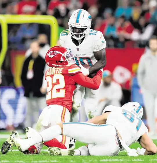  ?? NATHAN RAY SEEBECK USA TODAY Sports ?? Chiefs CB Trent McDuffie forces a fumble by Tyreek Hill in the second quarter. Safety Mike Edwards picked it up and lateraled to safety Bryan Cook, who ran for a 59-yard TD.