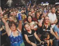  ?? AP PHOTO/JOHN LOCHER ?? People listen to Big & Rich perform during a benefit concert honouring first responders and those affected by the recent Las Vegas mass shooting. Some survivors said they were ready for closure, though they confessed feeling engulfed by anxiety and...