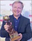  ?? Special to The Okanagan Weekend ?? Thompson Okanagan Tourism Associatio­n CEO Glenn Mandziuk holds the trophy the organizati­on won for the second year in a row as North America’s responsibl­e tourism leader at the World Travel Awards.