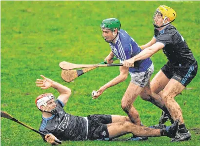  ??  ?? Paddy Purcell tries to pass the sliotar under pressure from Dublin’s Paddy Smyth (left) and Dáire Gray